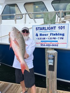 a person holding a fish