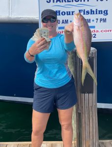 a person holding a fish